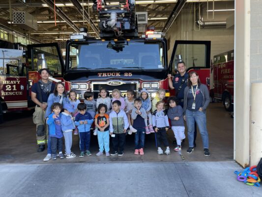 Pre-K students in front of a firetruck